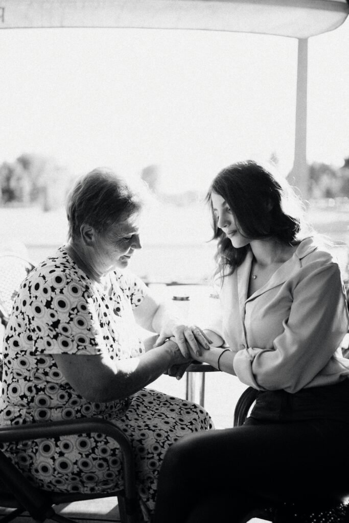 pexels-photo-17066496-17066496 A heartwarming black and white photo capturing a tender moment between a mother and daughter sitting together.